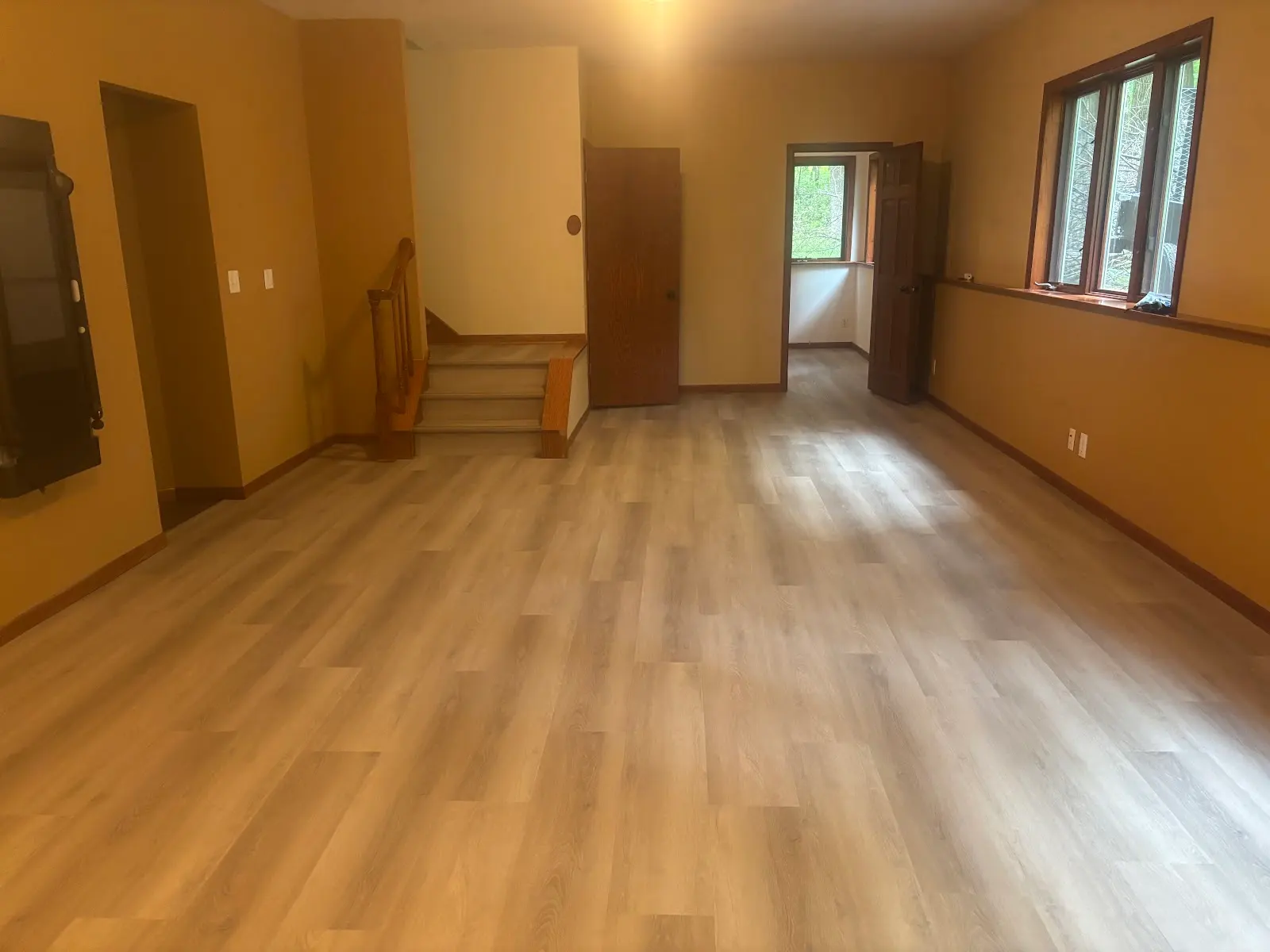 Light oak luxury vinyl plank throughout a spacious lower-level living area